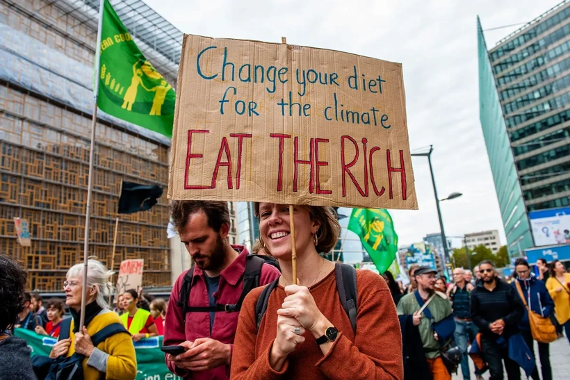 climate-protest-eat-the-rich-sign-1244186481-1.webp